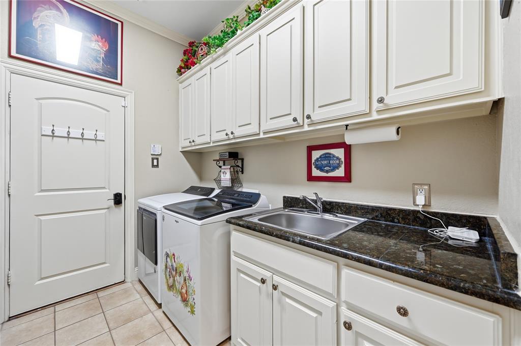 1316 Rio Grande Drive Allen, TX 75013 - Photo 20 of 40 a kitchen with granite countertop a sink and cabinets