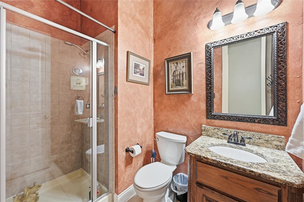 1316 Rio Grande Drive Allen, TX 75013 - Photo 21 of 40 a bathroom with a granite countertop sink toilet and shower