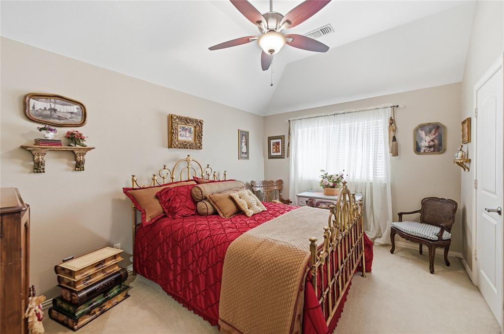 1316 Rio Grande Drive Allen, TX 75013 - Photo 31 of 40 a bedroom with a bed and a chandelier