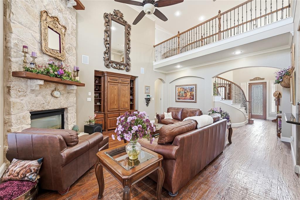 1316 Rio Grande Drive Allen, TX 75013 - Photo 10 of 40 a living room with furniture a fireplace and a chandelier