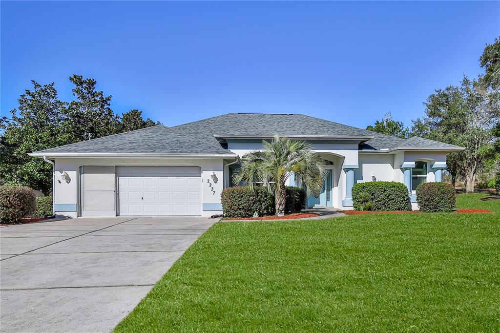 a front view of a house with a yard and garage