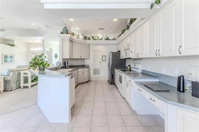 a white bed sitting in a bedroom next to a window