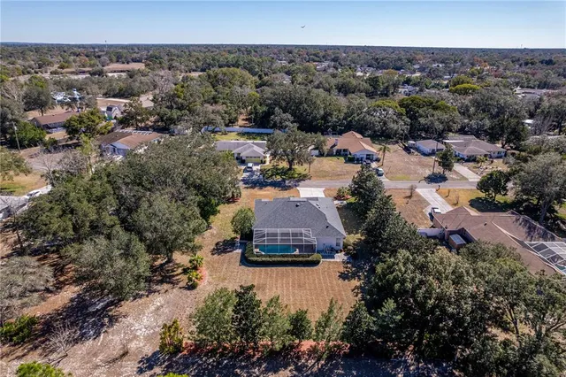 a view of a house with a yard and street