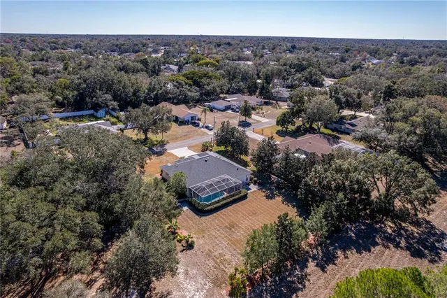 a view of a field with trees in the background