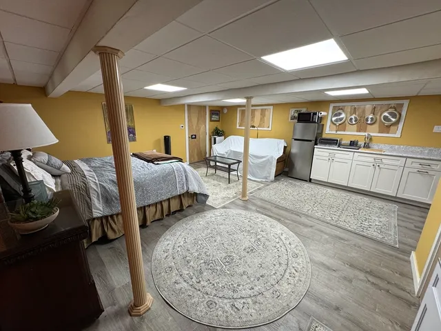 a bed room with furniture and a wooden floor