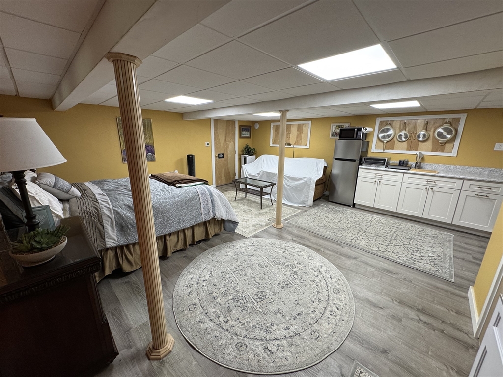 1292 Lenox Road, Unit 1 Richmond, MA 01254 - Photo 2 of 16 a bed room with furniture and a wooden floor