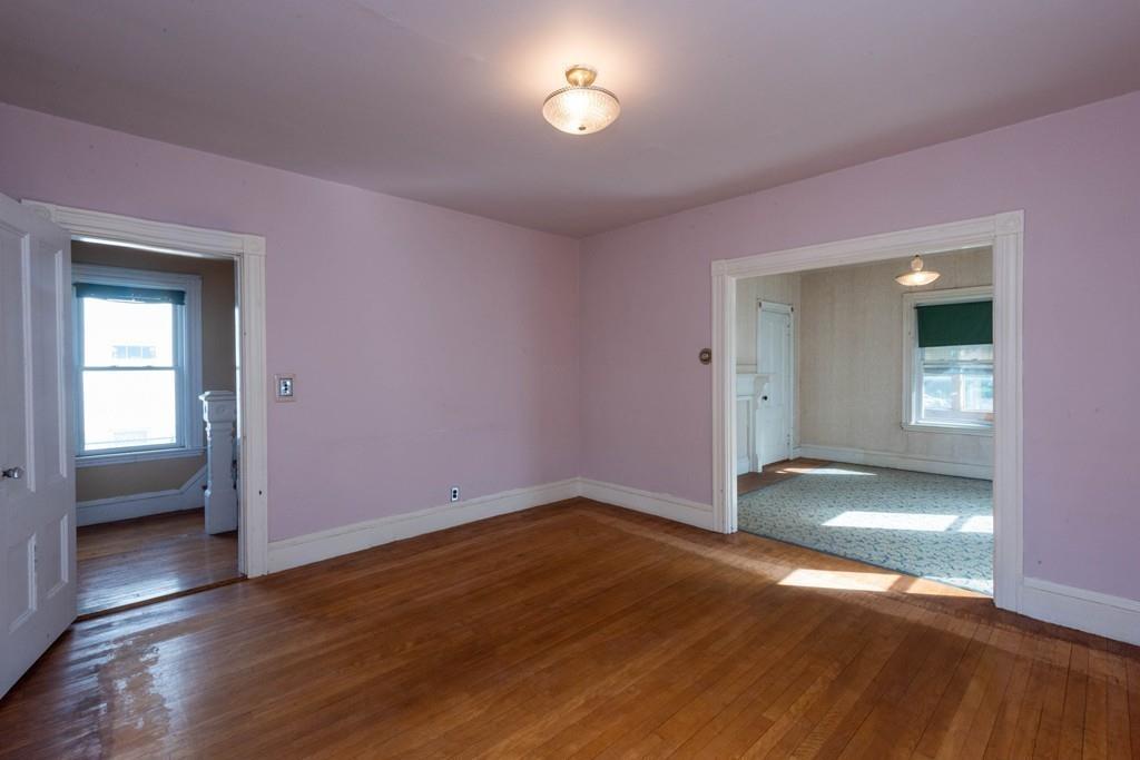 175 Riverside Avenue Medford, MA 02155 - Photo 11 of 38 an empty room with wooden floor and windows