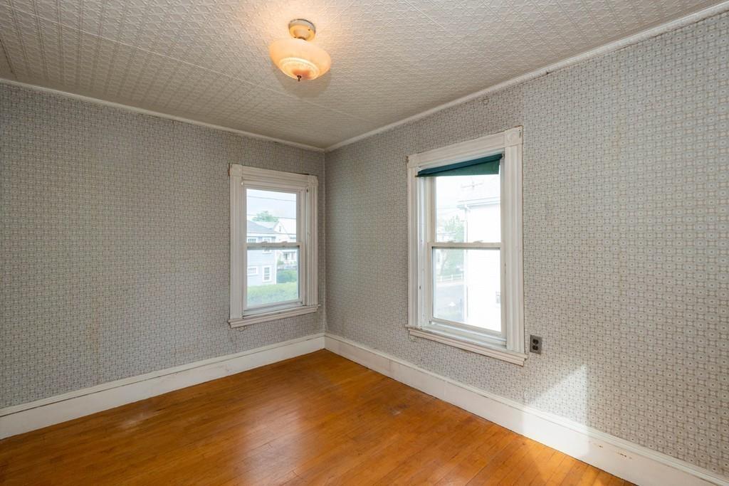 175 Riverside Avenue Medford, MA 02155 - Photo 14 of 38 an empty room with wooden floor and windows