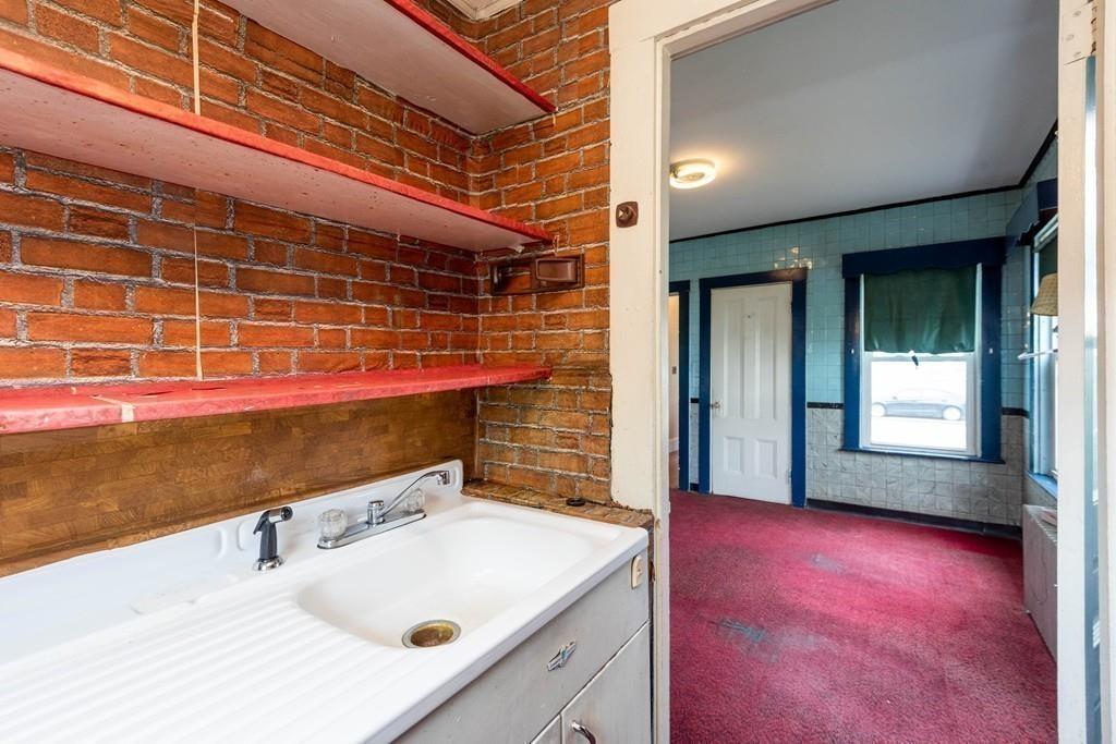 175 Riverside Avenue Medford, MA 02155 - Photo 31 of 38 a bathroom with a sink and a large mirror