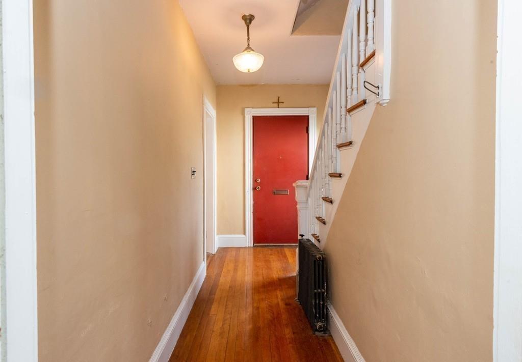 175 Riverside Avenue Medford, MA 02155 - Photo 4 of 38 a view of a hallway with wooden floor and staircase
