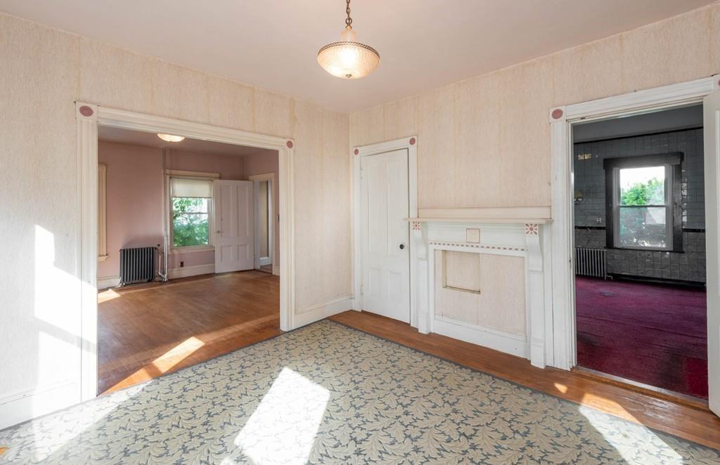 175 Riverside Avenue Medford, MA 02155 - Photo 6 of 38 a view of a hallway with wooden floor and cabinet