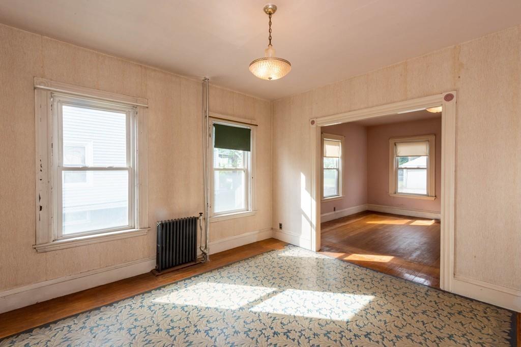 175 Riverside Avenue Medford, MA 02155 - Photo 7 of 38 a view of livingroom with window and hardwood floor