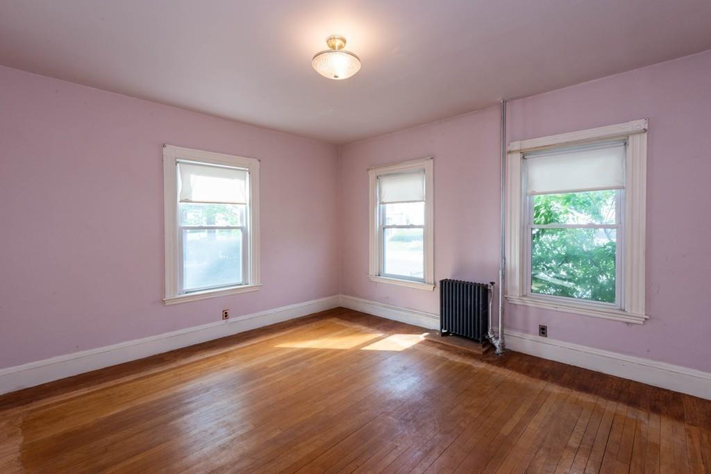175 Riverside Avenue Medford, MA 02155 - Photo 8 of 38 a view of an empty room with wooden floor and a window