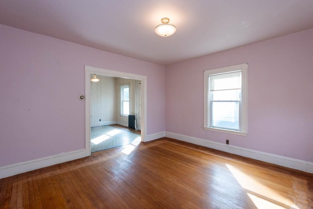 175 Riverside Avenue Medford, MA 02155 - Photo 9 of 38 an empty room with wooden floor and windows