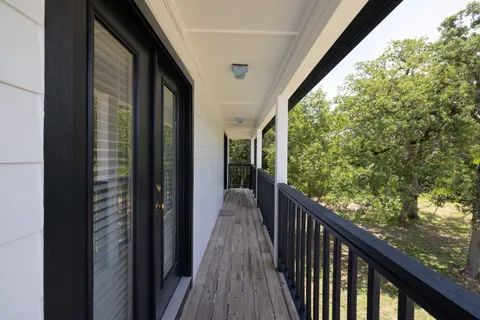 a view of a balcony with wooden floor