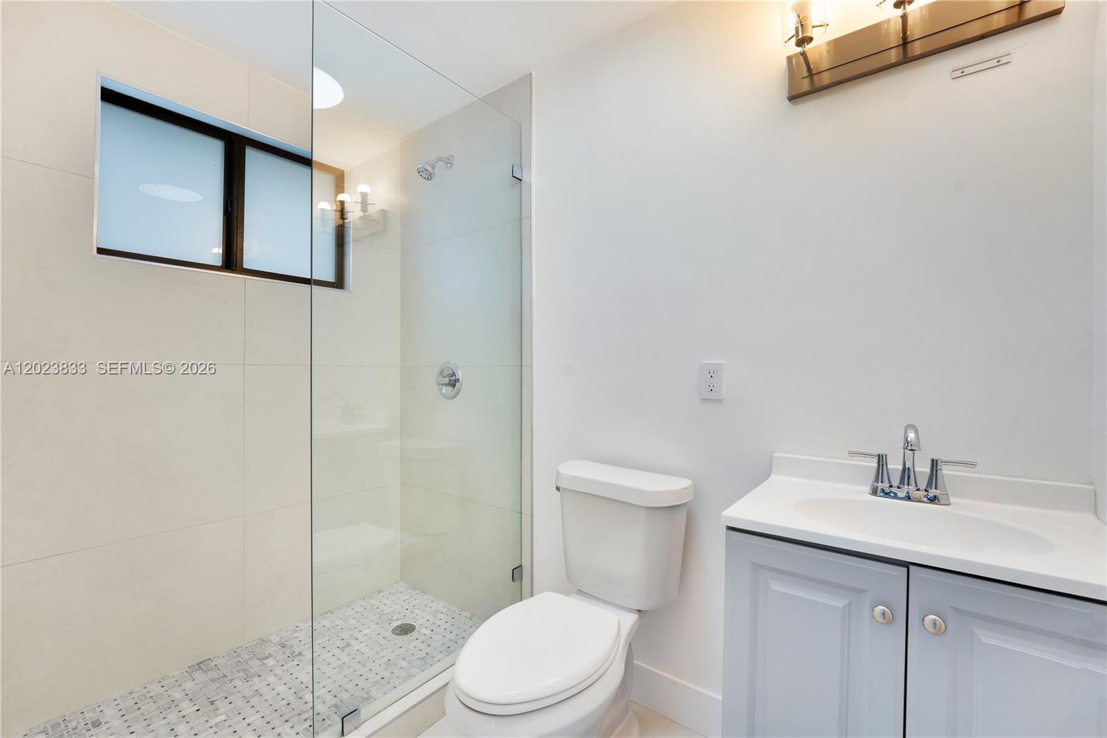 6566 Southwest 35th Street Miami, FL 33155 - Photo 26 of 36 a bathroom with a toilet a sink and shower