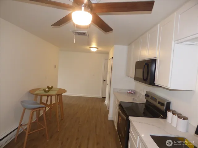 a kitchen with a sink cabinets and wooden floor