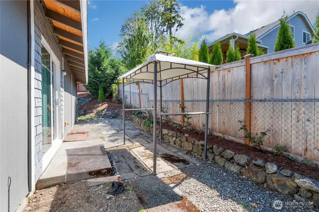 a view of a backyard with wooden fence