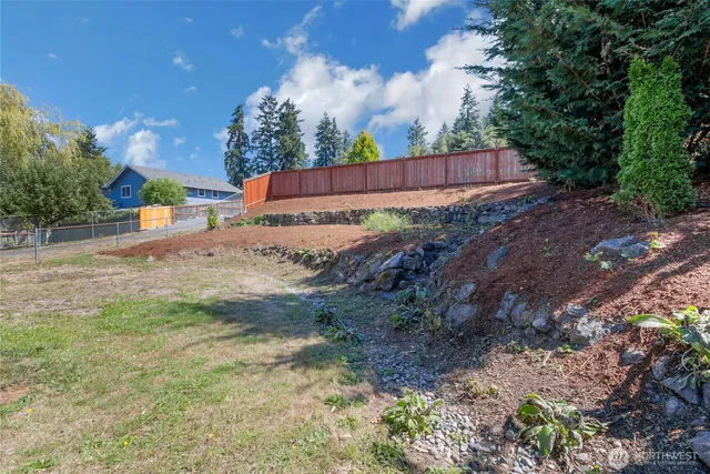 a view of small yard with wooden fence