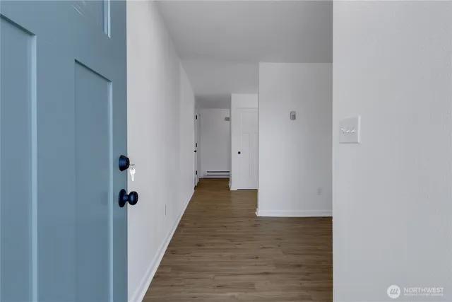 a view of a hallway with wooden floor