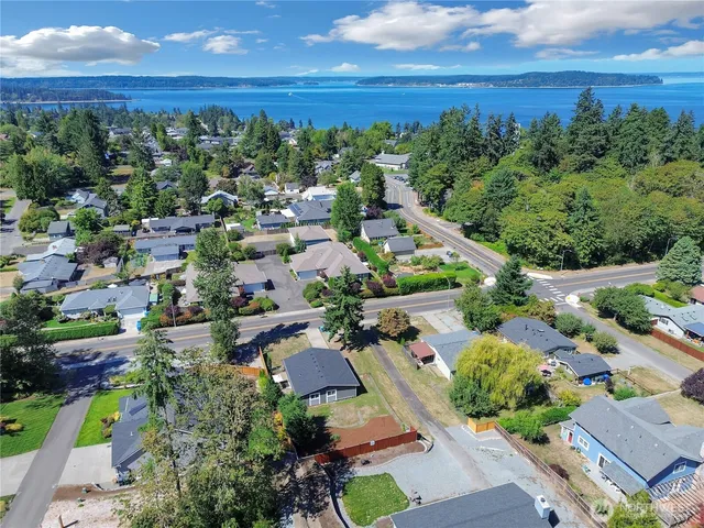 an aerial view of a houses with a yard
