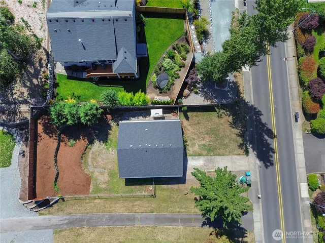 an aerial view of a house with a yard