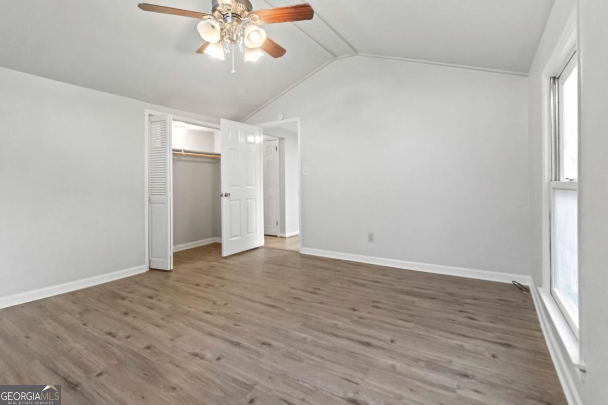 2312 Wayside Drive Brookhaven, GA 30319 - Photo 12 of 18 a view of an empty room with wooden floor and a window