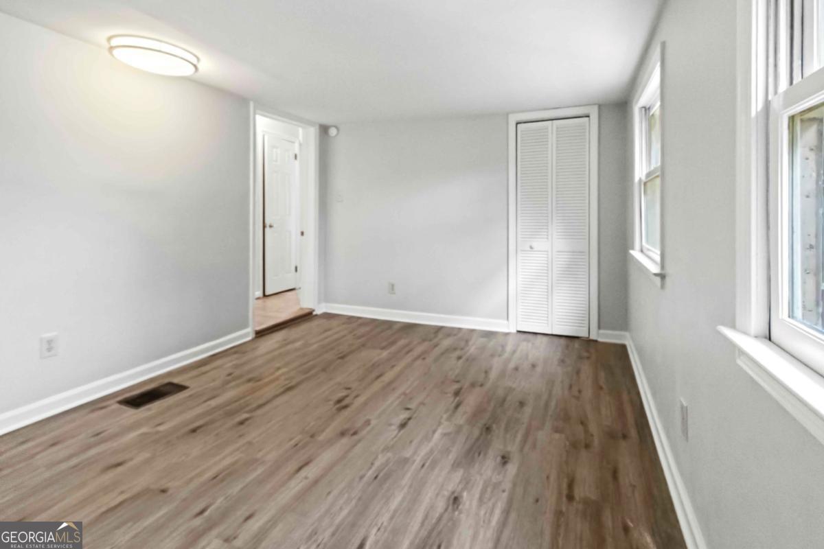 2312 Wayside Drive Brookhaven, GA 30319 - Photo 13 of 18 an empty room with wooden floor and windows