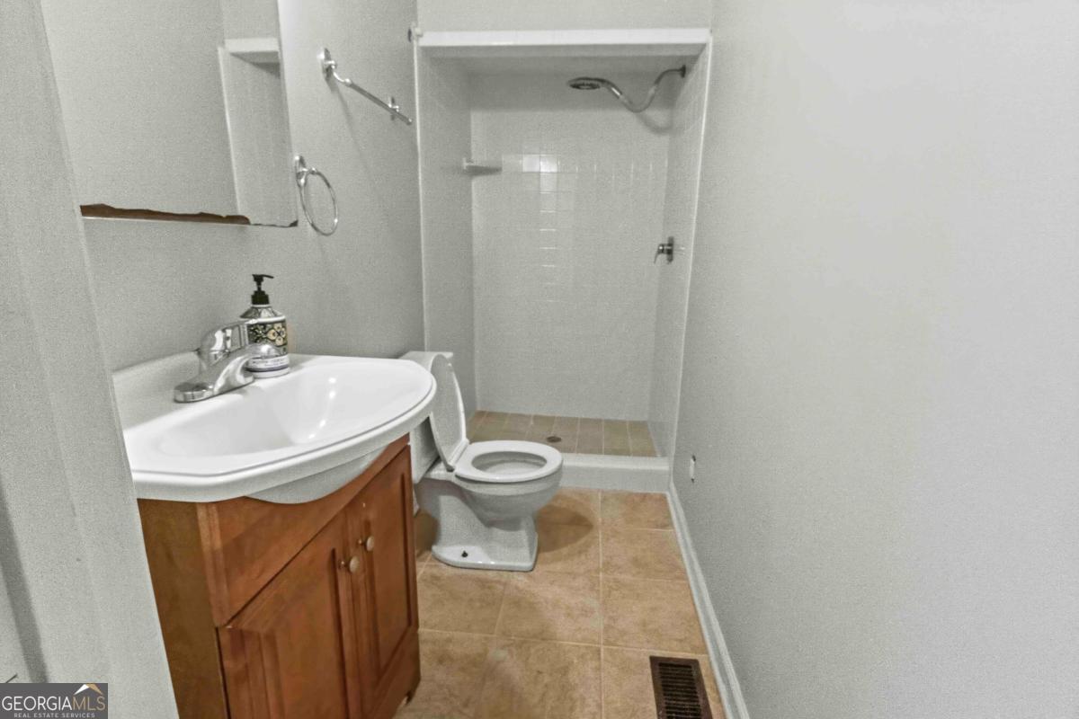 2312 Wayside Drive Brookhaven, GA 30319 - Photo 16 of 18 a bathroom with a sink a toilet and shower
