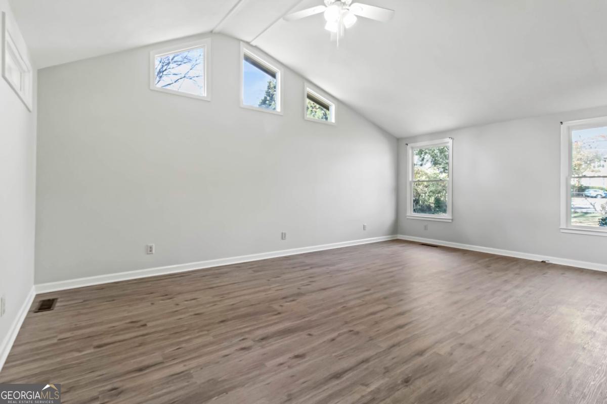 2312 Wayside Drive Brookhaven, GA 30319 - Photo 10 of 18 an empty room with wooden floor and windows