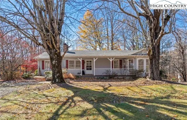 a front view of a house with a yard covered in snow