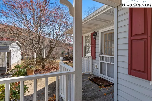 a view of a brick house with a tree