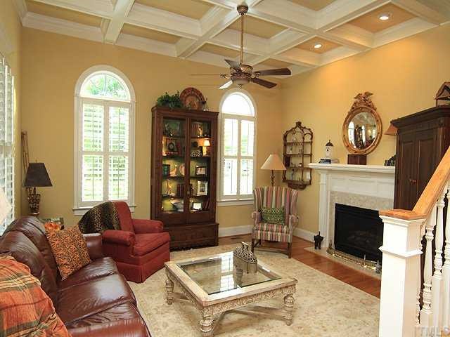 10323 Evergreen Spring Place Raleigh, NC 27614 - Photo 3 of 12 Cozy family room has 11 ft coffered ceilings, fireplace with gas logs and plantation shutters. Hardwoods are featured on first floor.