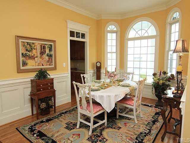 10323 Evergreen Spring Place Raleigh, NC 27614 - Photo 5 of 12 Lovely dinning room has bay window that overlooks porch. Beautiful wainscoating and transoms on first floor as well as extensive detailed mouldings.