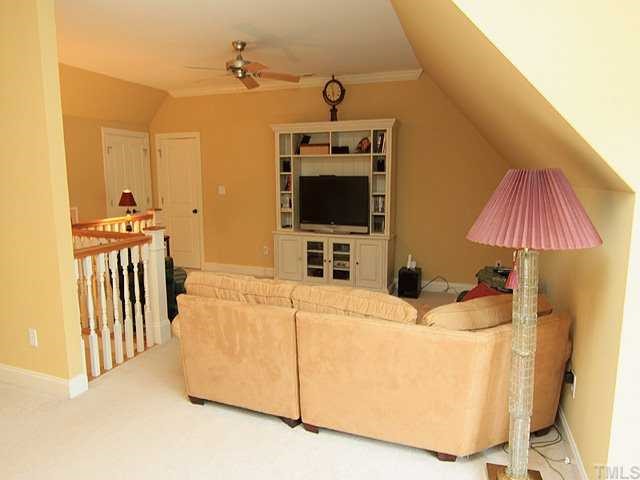 10323 Evergreen Spring Place Raleigh, NC 27614 - Photo 10 of 12 Large bonus/media room (24x22) has back stairway access as well as upstairs hall. Good walk-out storage off this room as well as pull down stairs for additional storage.