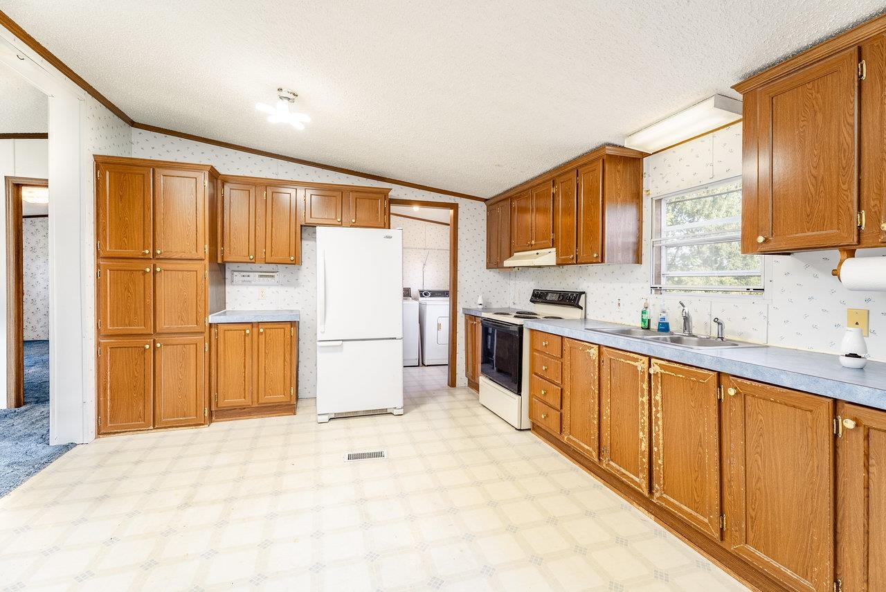 9072 Shultztown Road Linville, VA 22834 - Photo 15 of 51 a kitchen with a refrigerator sink stove microwave and cabinets