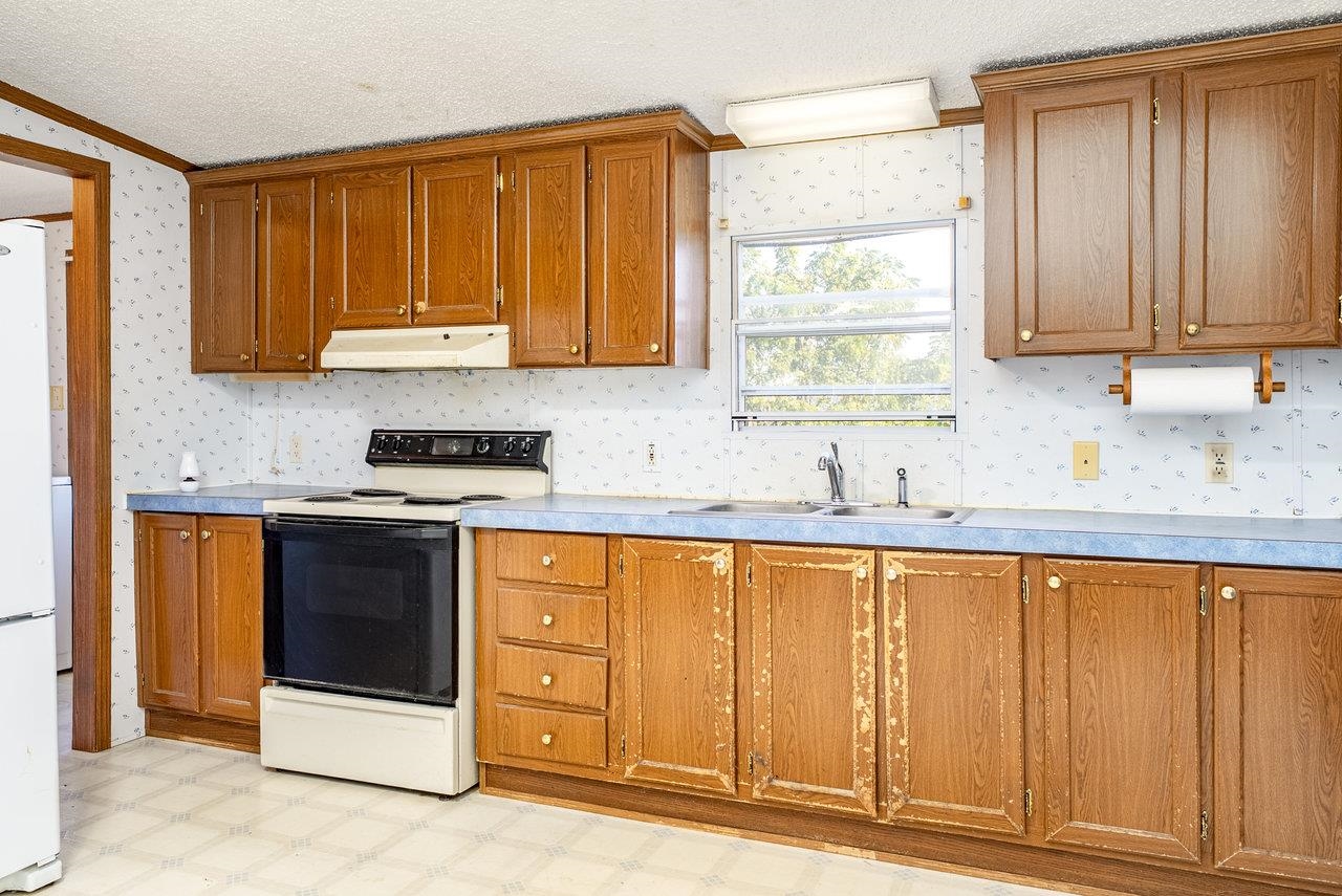 9072 Shultztown Road Linville, VA 22834 - Photo 16 of 51 a kitchen with stainless steel appliances granite countertop a stove a sink and a microwave