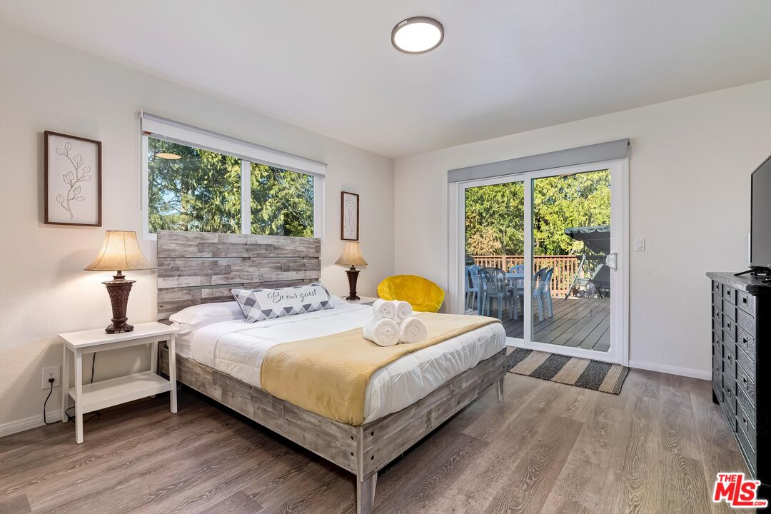 40902 Elliott Drive Oakhurst, CA 93644 - Photo 16 of 24 a bedroom with a bed and a large window