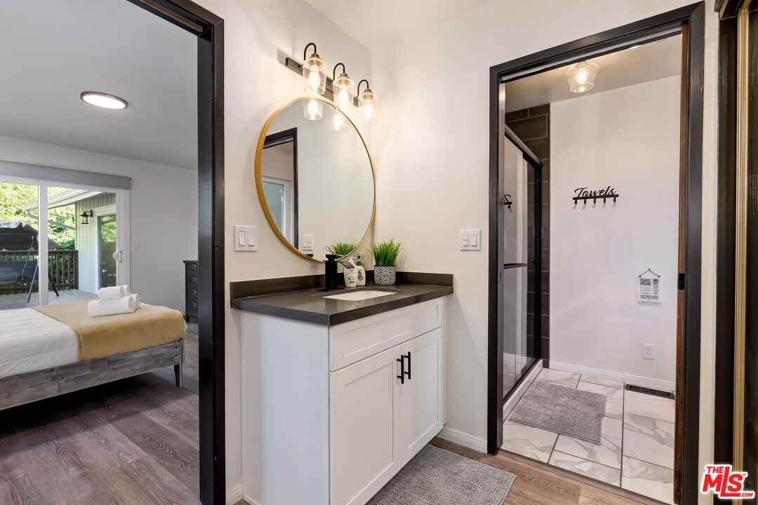 40902 Elliott Drive Oakhurst, CA 93644 - Photo 18 of 24 a en suite bathroom with a double vanity sink and a mirror