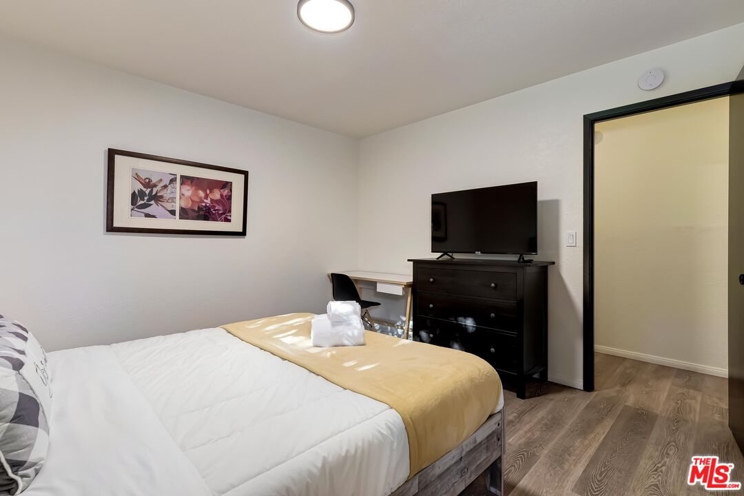 40902 Elliott Drive Oakhurst, CA 93644 - Photo 21 of 24 a bedroom with a bed and a flat screen tv