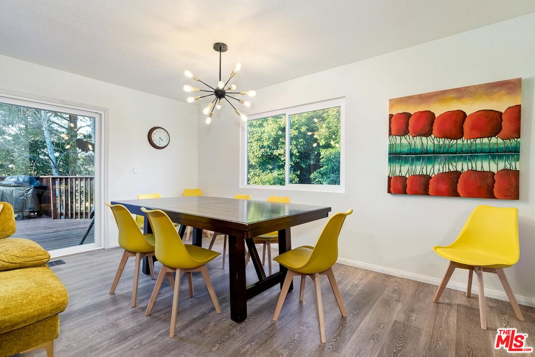 40902 Elliott Drive Oakhurst, CA 93644 - Photo 8 of 24 a view of a dining room with furniture a chandelier and wooden floor