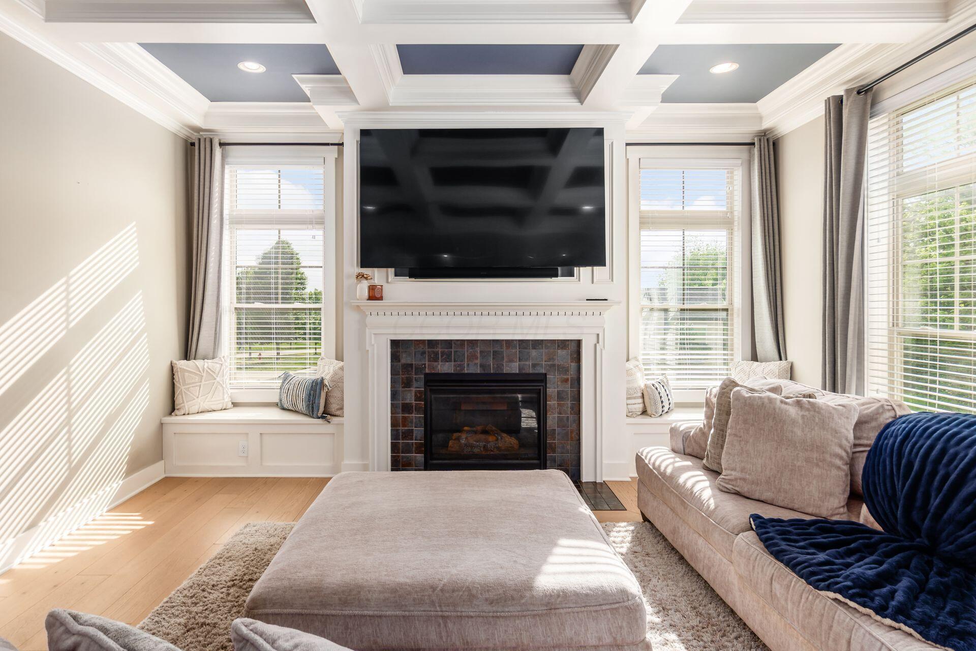1002 Rambling Brook Way Delaware, OH 43015 - Photo 14 of 104 Spacious Great Room with coffered ceiling, window benches and gas fireplace
