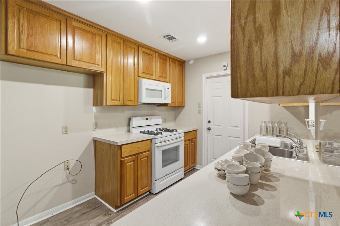 3905 Mariam Road Temple, TX 76502 - Photo 7 of 17 a kitchen with stainless steel appliances granite countertop a sink stove and cabinets