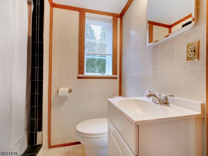 32 Cliffside Trail Denville, NJ 07834 - Photo 9 of 24 a bathroom with a sink a toilet and a mirror