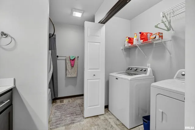 a view of storage and utility room with washer and dryer