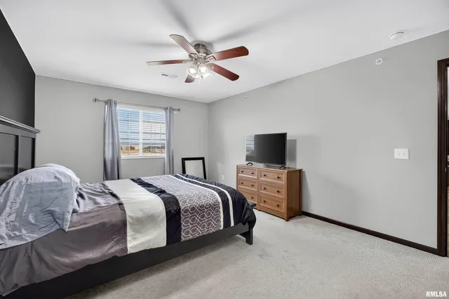 a bedroom with a large bed and a flat screen tv