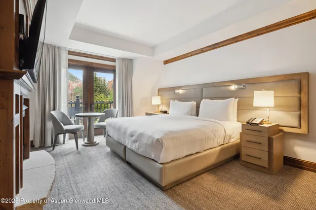 a bedroom with a large bed and a large window