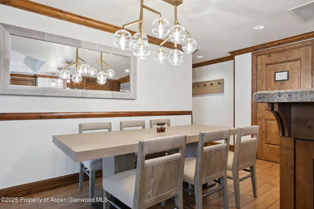 a view of a dining room with furniture and chandelier
