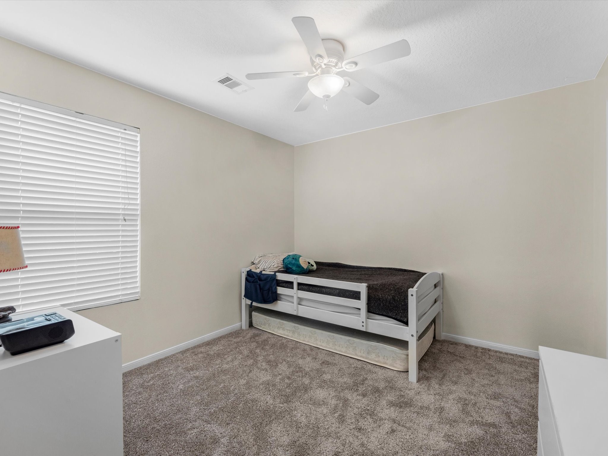 22422 Lamaster Lane Spring, TX 77373 - Photo 23 of 35 Third cozy bedroom with neutral walls, carpeted flooring, and a ceiling fan.