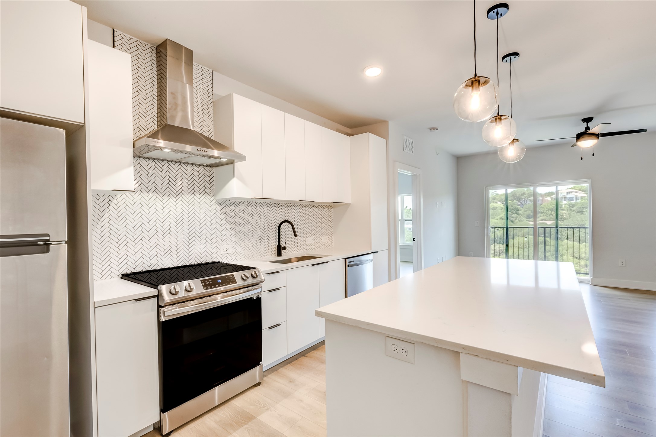 2500 Longview Street, Unit 402 Austin, TX 78705 - Photo 10 of 27 a kitchen with stainless steel appliances a sink a stove a refrigerator and cabinets